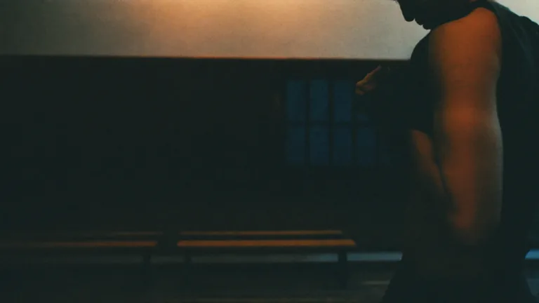 Man in a dim gym locker room
