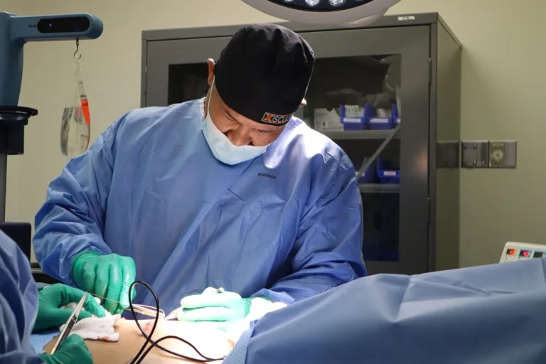 Dr. Marc Adajar performing surgery in the operating room at XSculpt